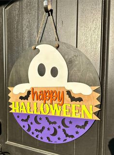 a halloween door hanger with a ghost on it