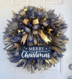 a blue and gold christmas wreath on a door