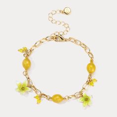 Experience the refreshing and invigorating essence of the Lemon Bracelet. Embrace nature with its sweet, juicy lemon design that evokes memories of sunny days, tropical vacations, and cool breezes. Let its vibrant flowers and fruit design add a touch of summer zeal to your style. Embrace the zesty spirit of summer and Celebrate the luxurious pleasures of nature's bounty with this delightful Lemon Bracelet! DETAILS Plating: 18K Gold Materials: 18K Gold on Brass, Enamel, Cubic Zirconia Measurement Lemon Bracelet, Flowers And Fruit, Lemon Design, Tropical Vacations, Nature's Bounty, Detailed Necklace, Embrace Nature, Holiday Gift Sets, Vibrant Flowers