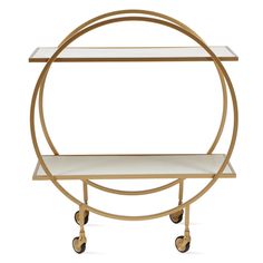 a gold metal and glass bar cart with wheels on each side, holding two shelves