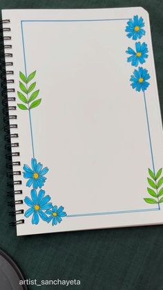 an open notebook with blue flowers on it