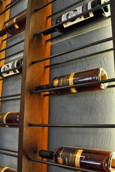 several bottles of wine are lined up on the wall