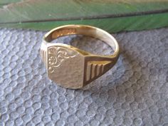 "9 Kt. Gold Signet Ring with Hallmarks for Birmingham, England, 9 Kt. Gold, 1970 and \"C.P.S.\" for a maker's mark.  There is room to place a monogram, but we do not have the equipment to engrave the ring here. This ring is in excellent condition with light scratching to the surface.  It weighs 5 grams." Formal Engraved Ring With Maker's Mark, Vintage Formal Initial Ring, Gold Rings Vintage, Mens Gold Signet Rings, Cowboy Gifts, A Night At The Opera, Ring Inspo, Estate Rings, Mens Gold Rings