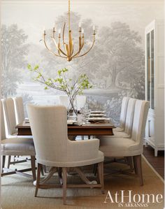 a dining room table with chairs and a chandelier