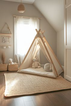 a child's room with a teepee tent and stuffed animals on the floor