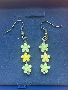 Multicolored Flower dangling Earrings  * Handmade Jewelry  * Flower shaped beads  * 2 green flowers, 1 yellow flower Gift wrapped upon arrival when requested from buyer. Adjustable Green Jewelry With Handmade Flowers, Yellow Earrings With Flower Decoration For Gift, Yellow Flower Decoration Earrings As Gift, Green Dangle Flower Earrings For Gift, Yellow Earrings With Flower Decoration, Green Flower Beaded Earrings For Gift, Green Flower Earrings For Gifts, Green Flower Shaped Jewelry With Floral Decoration, Green Flower Beaded Earrings Gift