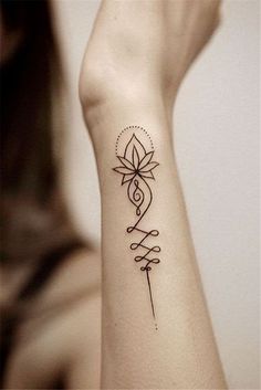 a woman's arm with a tattoo on the wrist and an arrow in the middle