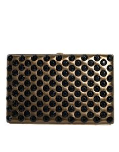 a metal plate with black dots on it