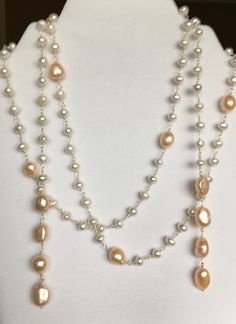 "This pearl necklace has been made from pearls of varying sizes and shapes in a nice creamy color.  These were designed by Vantel Pearls, and was named the \"Pearly Pizazz Lariat\", who have retired and closed their doors.  The strand is approximately 50\" long, and can be worn many ways.  This is a lariat necklace, which has no clasp.  If you check out my photos, you will see a list of the many ways a lariat chain can be worn and enjoyed, even as a bracelet.   Please remember that this could ship free if you were to buy another item, as I offer combined shipping." Cream Pearl Drop Necklace For Party, White Pearl Lariat Necklace For Party, Cream Pearl Drop Necklaces With Round Beads, Party White Pearl Lariat Necklace, Cream Pearl Drop Necklace With Round Beads, Pearl White Pearl Lariat Necklace, Elegant Handmade Cream Pearl Necklace, White Lariat Pearl Necklace With Pearl Drop, White Pearl Lariat Necklace With Pearl Drop