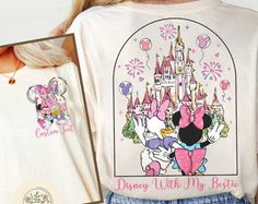 a woman holding up a disney shirt with minnie and mickey mouse on it's back