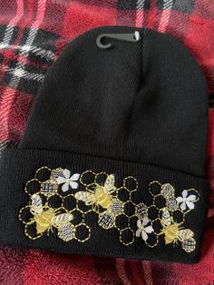 "Whimsical Golden Busy Queen Bees to keep your head warm.  Hat is 100% Acrylic, soft and warm. Hand wash only.  Hat measurements: appox. 12\" long unfolded, approx. 9\" long folded, width is approx 8 1/2\" on one side when flat, lots of stretch. Machine Embroidered." Golden Queen, Bee Hat, Queen Bees, 2 On, Beanie Hat, Your Head, Beanie Hats, Caps Hats, Accessories Hats