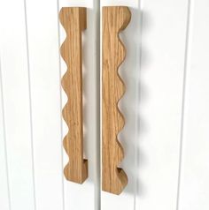 two wooden handles on the side of a white door