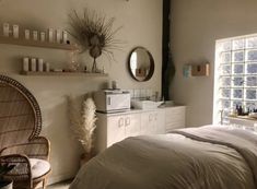 a bed sitting in a bedroom next to a window with lots of shelves on it