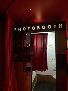 the photo booth is decorated with red curtains