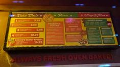 the menu for pizza place is displayed on the wall