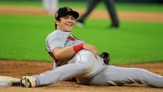 a baseball player is laying on the ground