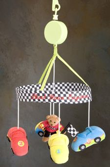 a baby mobile with toys hanging from it's sides and a teddy bear in the middle