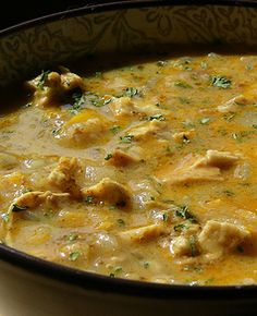 a bowl of soup with chicken and cheese