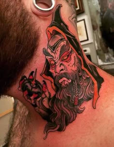 a man with a beard has a tattoo on his neck