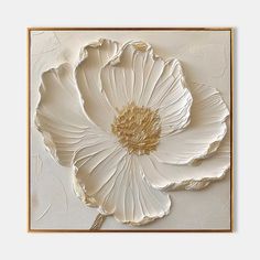 a large white flower is mounted on the wall