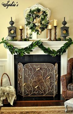 a fireplace decorated for christmas with wreaths, candles and other holiday decorating items