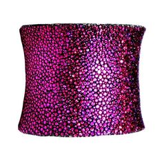 a pink and purple lamp shade with spots on it's side, against a white background