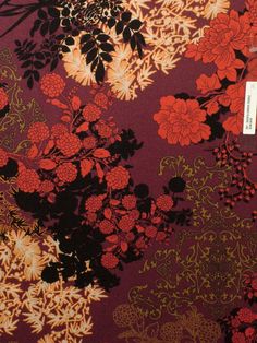 a red and black floral wallpaper with flowers on it