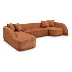 a large sectional couch with pillows on it's back and side facing the camera