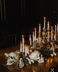 a table topped with skulls and candles