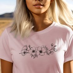 Embrace simplicity and elegance with our Minimalistic White Wildflowers Unisex Jersey Short Sleeve T-shirt. This timeless tee features a clean and minimalistic design of white wildflowers, offering a versatile and sophisticated look. #11 Boho Classic unisex jersey short sleeve tee fits like a well-loved favorite. Soft cotton and quality print make users fall in love with it over and over again. Ribbed knit collars to bolster shaping. Shoulders are tapered for a better fit over time. Dual side seams hold the garment's shape for longer. Fabric Details Made with 100% Airlume combed and ring-spun cotton, a lightweight fabric (4.2 oz/yd² (142 g/m²)) that is easy to layer, breathable. Perfect for active and leisure wear. Style Features The retail fit is perfect for casual and semi-formal setting White Minimalist T-shirt For Spring, Feminine Crew Neck T-shirt For Spring, Feminine White Crew Neck T-shirt, White Feminine Crew Neck T-shirt, Feminine White T-shirt For Spring, Minimalist Short Sleeve T-shirt For Spring, Minimalist Tshirt Design, Minimalist Tshirt, White Wildflowers