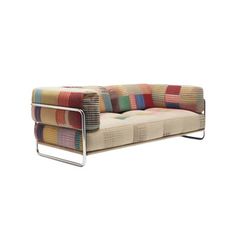 a multicolored couch sitting on top of a metal frame