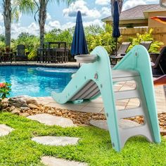 a pink slide next to a swimming pool