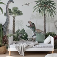 a bedroom with dinosaurs and palm trees on the wall