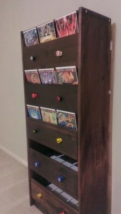 a wooden book shelf with many books on it's sides and two drawers in the middle