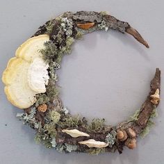 a wreath made out of branches with shells and other things on the top of it