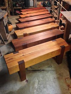 several wooden benches lined up in a workshop