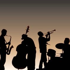 silhouettes of people playing instruments in front of a sunset