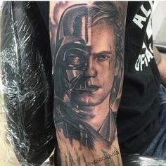 a man with a darth vader tattoo on his arm is shown in black and grey