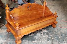 a wooden bed frame sitting on top of a floor