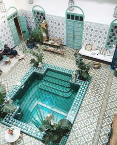 an indoor swimming pool in the middle of a room