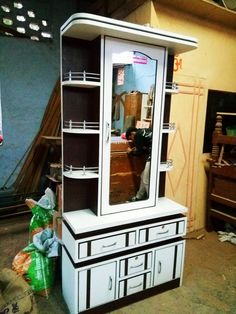 a white and black china cabinet with mirror on top