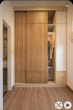 an open closet with wooden slats on the doors