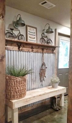 a wooden bench with two plants on it and some lights hanging from the ceiling above