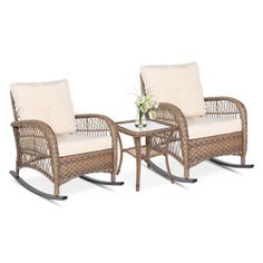 two wicker rocking chairs and table with white cushions on an isolated white background, set against a plain backdrop