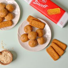 two plates with cookies on them next to a box of biscuits