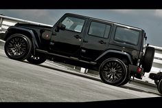 two black jeeps parked next to each other