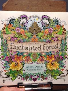 the front cover of an enchanted forest coloring book with flowers and leaves on it