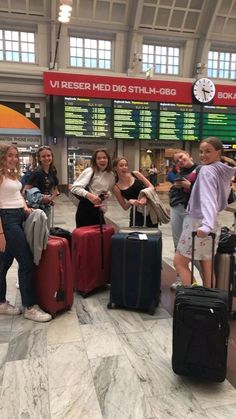 group of people standing around with their luggage