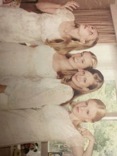 three women in white dresses standing next to each other with their hands on their hips