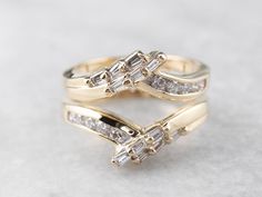 two gold wedding rings with diamonds on them